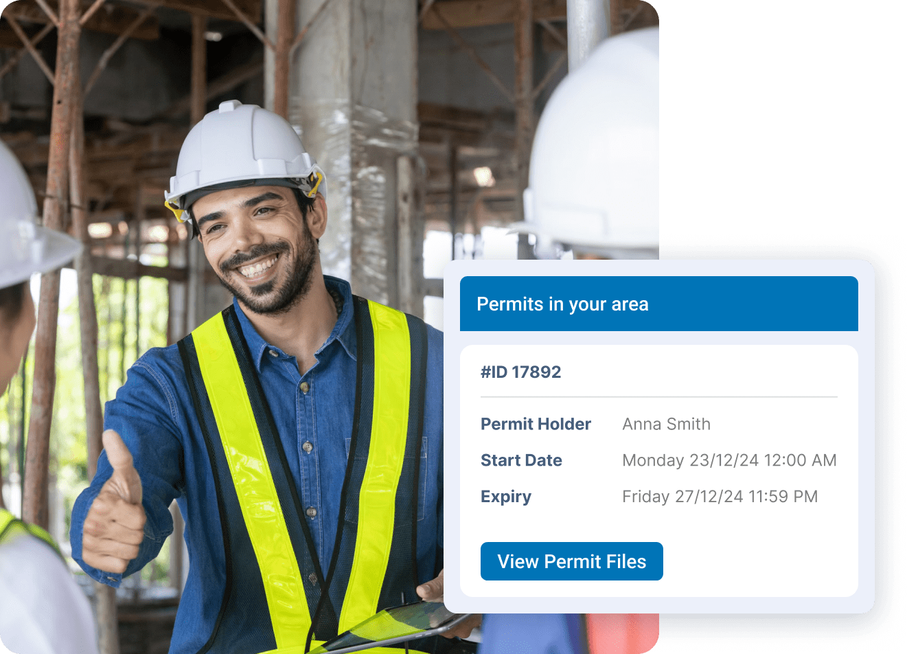 Smiling construction worker in hard hat giving thumbs up with permit details displayed